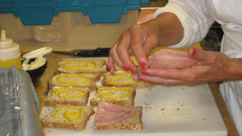 volunteer making sandwiches