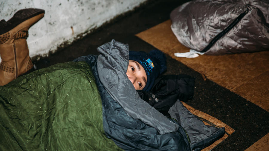 A participant trying to sleep in the rain