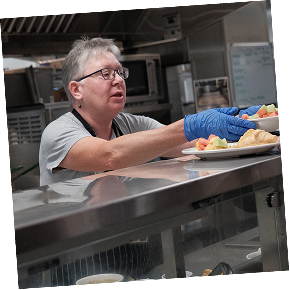 Jennifer, CHV volunteer, serving a meal